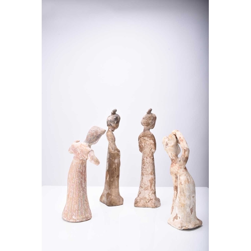 28 - Four Chinese pottery figures of maidens, Tang Dynasty Modelled wearing long robes and differing in p... 