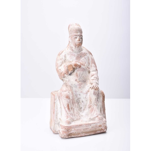 30 - A Chinese buff pottery figure of a seated official, Tang Dynasty 20.5cm high