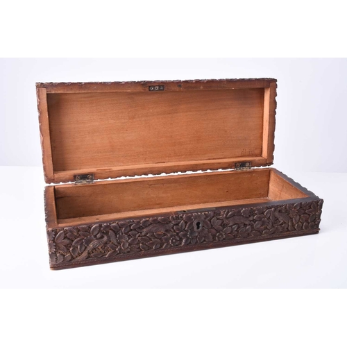 301 - An Indian carved wood box, late 19th century Of rectangular outline and carved in relief with dense ... 