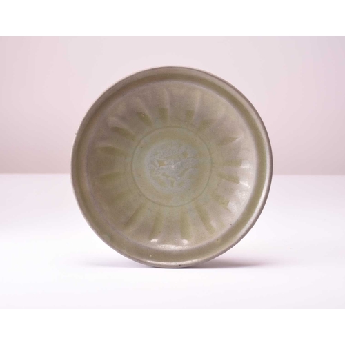 4 - A Chinese Longquan celadon dish, Ming Dynasty Of circular form with everted rim, the centre carved w... 