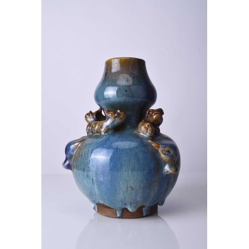 40 - A Chinese relief moulded flambe vase, early 20th century Of double gourd form with three ox head 'ha... 