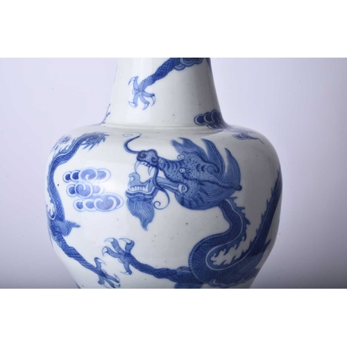 53 - A Chinese blue and white dragon vase, Jiaqing Of baluster form and decorated with three dragons chas... 