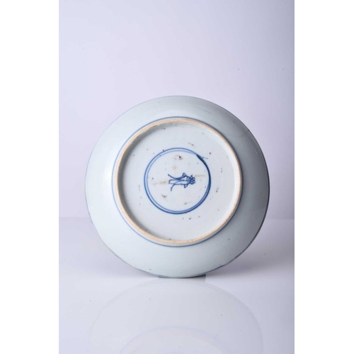 57 - A Chinese blue and white dish, Kangxi Of shallow rounded form, decorated with phoenix birds to the r... 