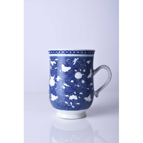 61 - A Chinese blue and white mug, 18th century Of bell form and decorated with bianco-sopra-bianco flowe... 