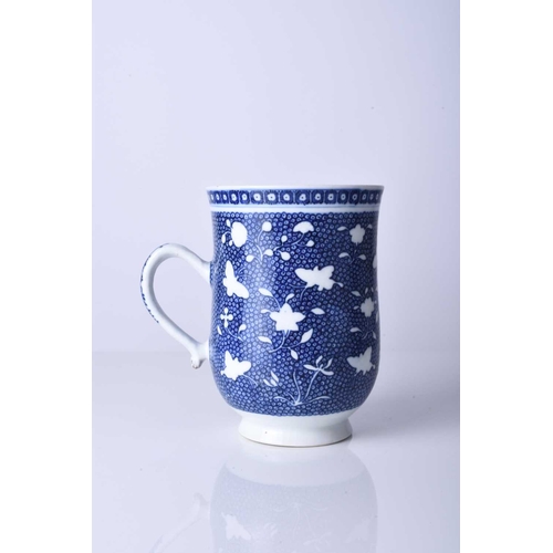 61 - A Chinese blue and white mug, 18th century Of bell form and decorated with bianco-sopra-bianco flowe... 