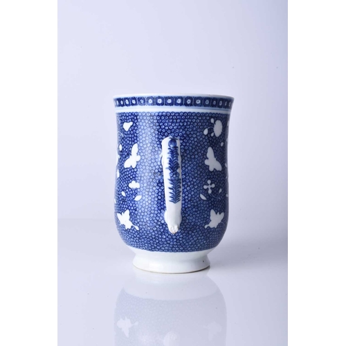 61 - A Chinese blue and white mug, 18th century Of bell form and decorated with bianco-sopra-bianco flowe... 