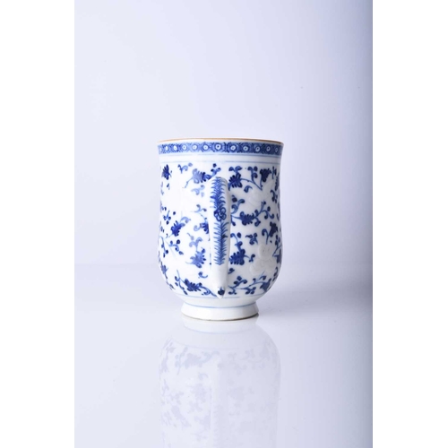 62 - A Chinese blue and white mug, 18th century Of bell form with plain loop handle, decorated with bianc... 