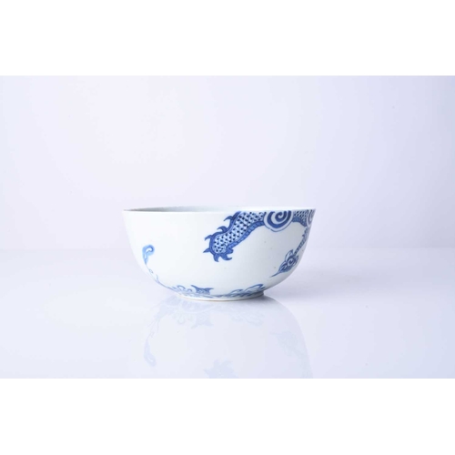 64 - A Chinese 'Bleu de Hue' blue and white dragon bowl, 18th century Of plain rounded form, decorated wi... 