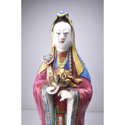 71 - A Chinese famille rose figure of Guanyin, Qing Dynasty, 19th century The Goddess of Mercy modelled b... 