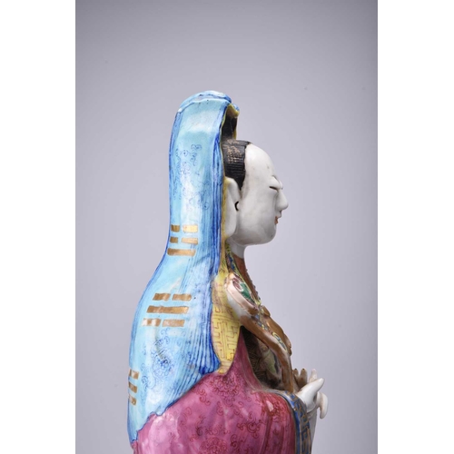 71 - A Chinese famille rose figure of Guanyin, Qing Dynasty, 19th century The Goddess of Mercy modelled b... 