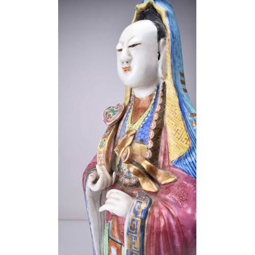 71 - A Chinese famille rose figure of Guanyin, Qing Dynasty, 19th century The Goddess of Mercy modelled b... 