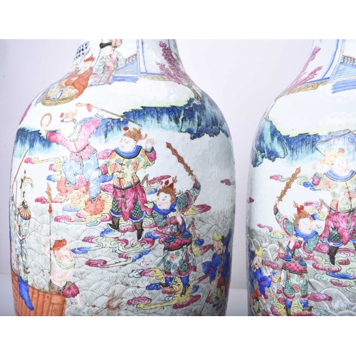 73 - A pair of large Chinese famille rose vases, 19th century Of ovoid form, decorated with opposing scen... 