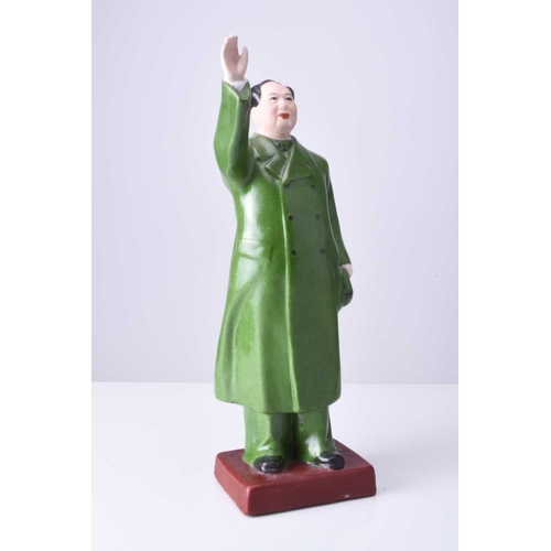 74 - A Chinese propaganda porcelain figure of Mao Tse Tung Modelled standing with right hand raised, he w... 