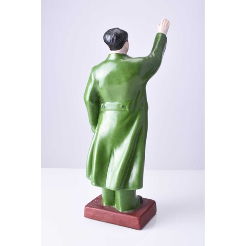 74 - A Chinese propaganda porcelain figure of Mao Tse Tung Modelled standing with right hand raised, he w... 