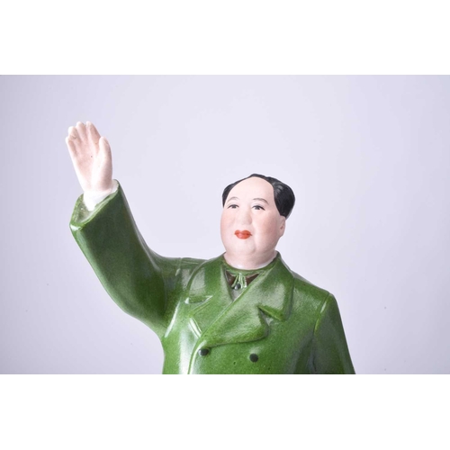 74 - A Chinese propaganda porcelain figure of Mao Tse Tung Modelled standing with right hand raised, he w... 