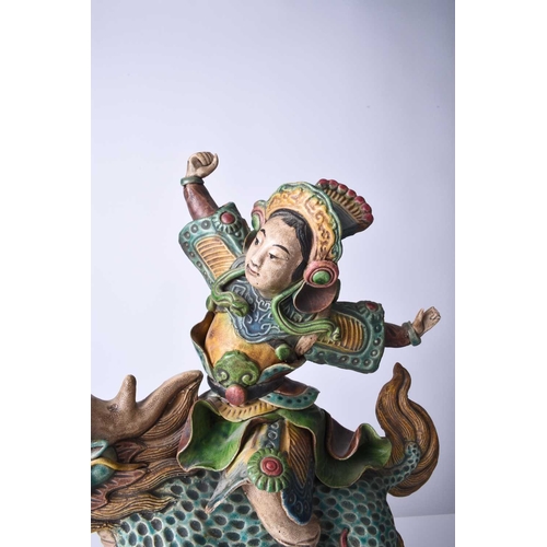 76 - A Chinese Shiwan pottery figural temple tile, Qing Dynasty Modelled as a warrior or immortal riding ... 