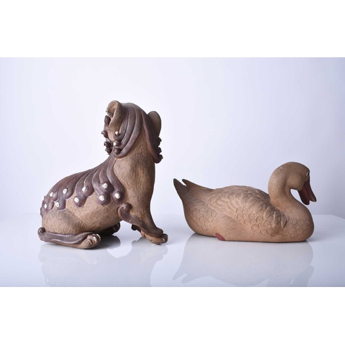 88 - Two Shiwan pottery figures, Qing Dynasty The first modelled as a seated lion dog, 18cm (front leg re... 