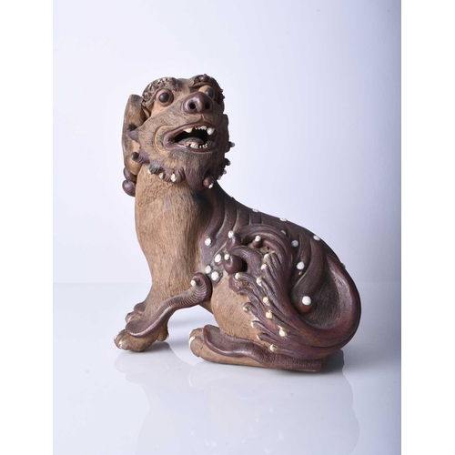 88 - Two Shiwan pottery figures, Qing Dynasty The first modelled as a seated lion dog, 18cm (front leg re... 