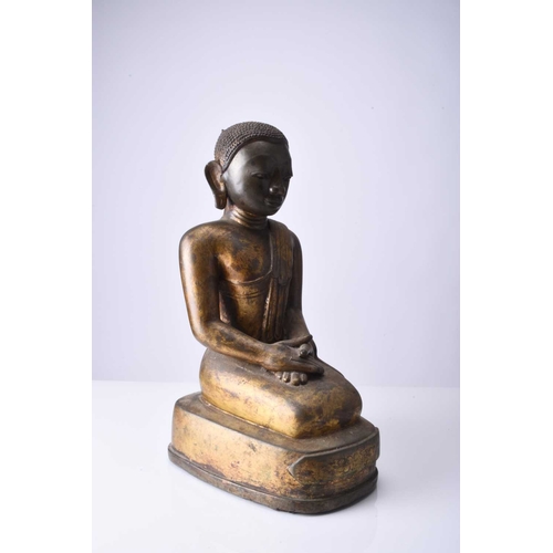 90 - A Burmese gilt bronze figure of a seated monk, late Qing Dynasty Modelled in kneeling position and w... 