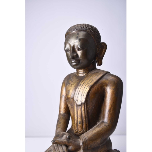 90 - A Burmese gilt bronze figure of a seated monk, late Qing Dynasty Modelled in kneeling position and w... 