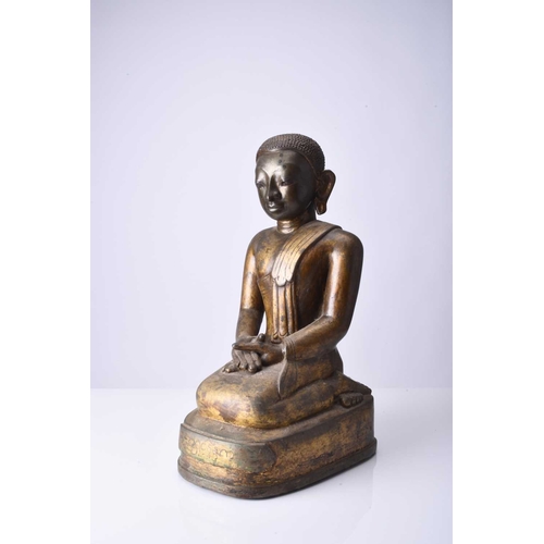 90 - A Burmese gilt bronze figure of a seated monk, late Qing Dynasty Modelled in kneeling position and w... 