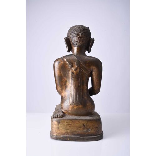 90 - A Burmese gilt bronze figure of a seated monk, late Qing Dynasty Modelled in kneeling position and w... 