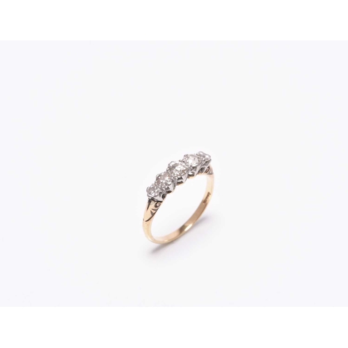 224 - A graduated five stone diamond ring, the transition cut diamonds claw set in white metal to yellow m... 