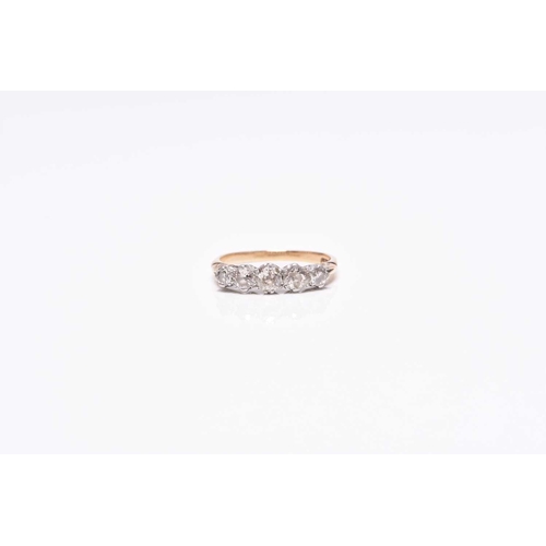 224 - A graduated five stone diamond ring, the transition cut diamonds claw set in white metal to yellow m... 