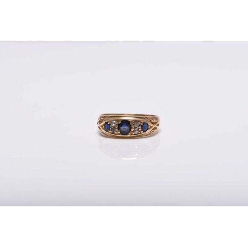 372 - An Edwardian 18ct gold seven stone diamond and untested sapphire ring, the graduated round and oval ... 