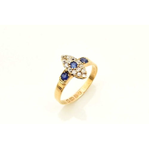 374 - An 18ct gold Edwardian sapphire and diamond ring, designed as a central round cut sapphire claw set ... 