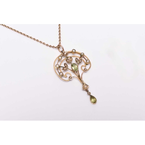 377 - An early 20th century peridot and seed pearl pendant on chain, the openwork pendant of stylised fan ... 