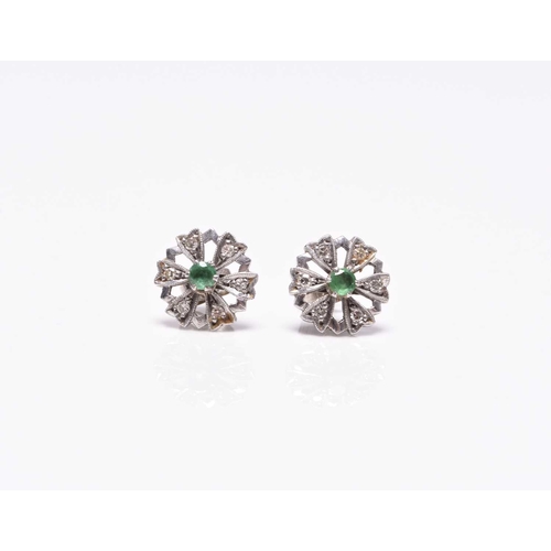 387 - A pair of emerald and diamond floral cluster earrings, each designed as a central round faceted emer... 