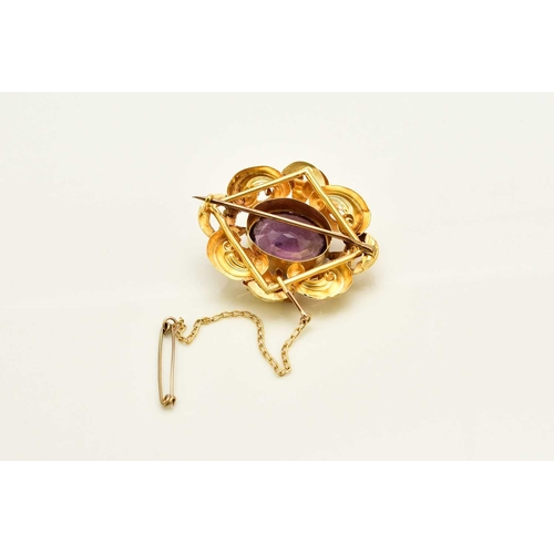 388 - A Victorian amethyst brooch, designed as a central oval mixed cut amethyst claw set within a yellow ... 