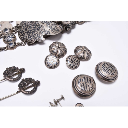 39 - A Russian silver niello work belt, the scrolling panel clasp secured with novelty Kindjal, together ... 