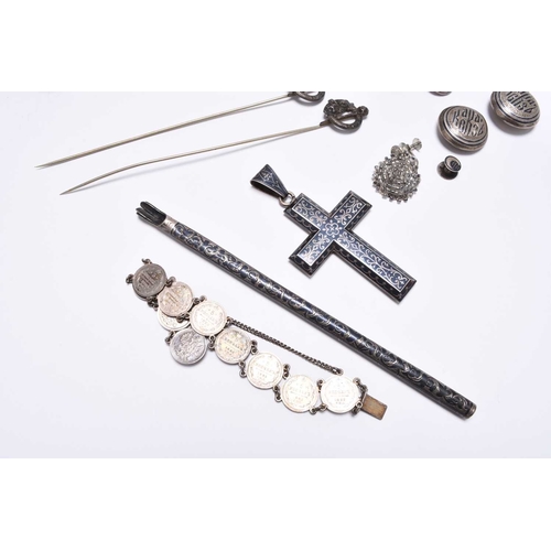 39 - A Russian silver niello work belt, the scrolling panel clasp secured with novelty Kindjal, together ... 