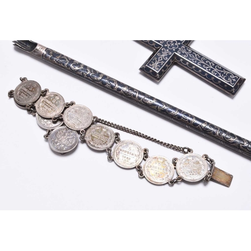 39 - A Russian silver niello work belt, the scrolling panel clasp secured with novelty Kindjal, together ... 