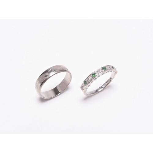 391 - An 18ct white gold wedding band, size N, weight approx 3.5g, together with an emerald and diamond ha... 