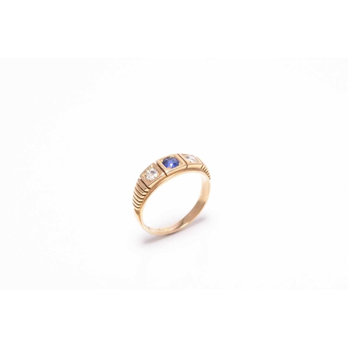 394 - An early 20th century three stone untested sapphire and diamond ring, the shank stamped 18ct, ring... 