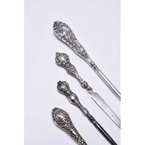 54 - A collection of silver mounted dressing table wares, comprising; a hand mirror with rose metal embel... 