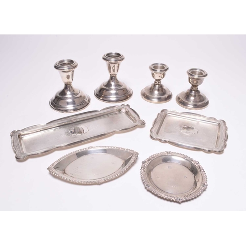 62 - A pair of silver mounted short candlesticks, Birmingham 1967, 6.5cm high, together with a pair of wh... 