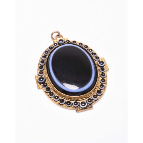 17 - A late 19th century banded agate pendant with locket reverse, designed a central oval agate plaque m... 
