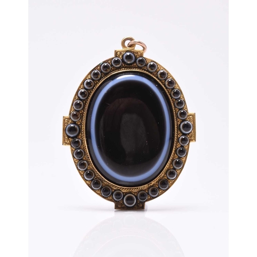17 - A late 19th century banded agate pendant with locket reverse, designed a central oval agate plaque m... 