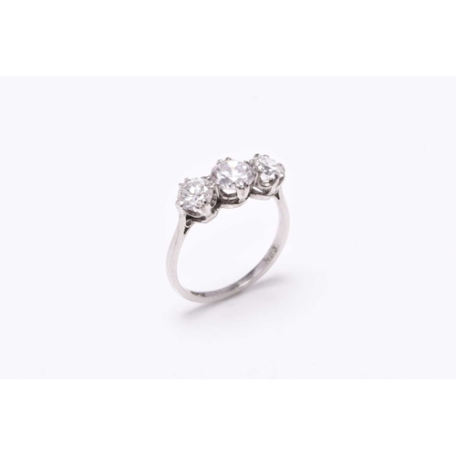 19 - A graduated three stone diamond ring, the brilliant cut diamonds claw set in white metal to white me... 