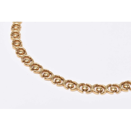 21 - An 18ct yellow gold decorative link necklace, the stylised cross and circular links with integral cl... 