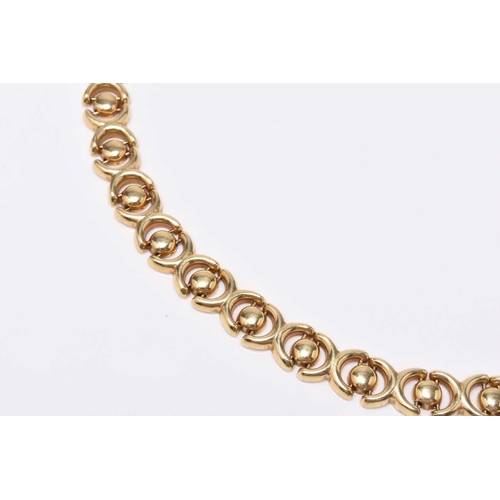 21 - An 18ct yellow gold decorative link necklace, the stylised cross and circular links with integral cl... 