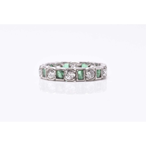 27 - An emerald and diamond eternity ring, designed as alternating old cut diamonds and rectangular cut e... 