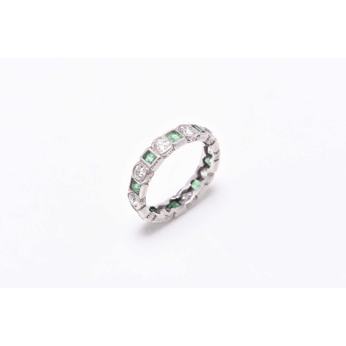 27 - An emerald and diamond eternity ring, designed as alternating old cut diamonds and rectangular cut e... 
