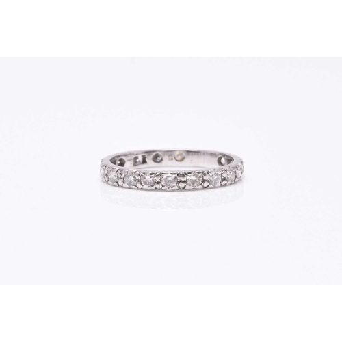 29 - A diamond eternity ring, the brilliant cut diamonds claw set in white metal, ring size M, weight app... 