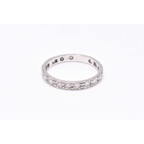 29 - A diamond eternity ring, the brilliant cut diamonds claw set in white metal, ring size M, weight app... 