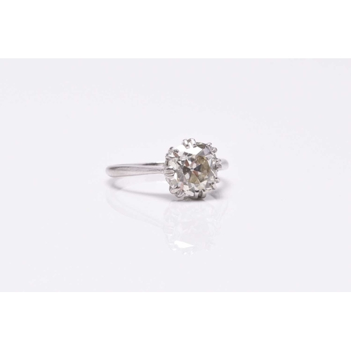 31 - A single stone diamond ring, the cushion cut diamond claw set in white metal to white metal shank, s... 